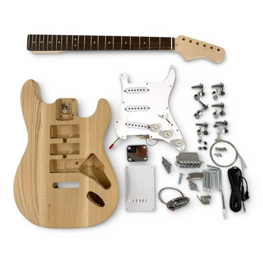 DIY electric guitar kit laid flat showing ash body, maple neck, pickguard, and all solderless wiring components organized