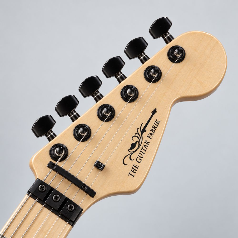 Custom logo waterslide decal in black on a natural maple guitar headstock