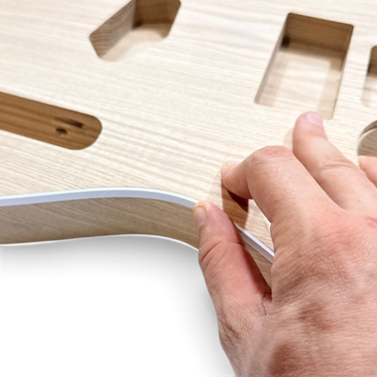 Pressing the binding strip into the channel of the body
