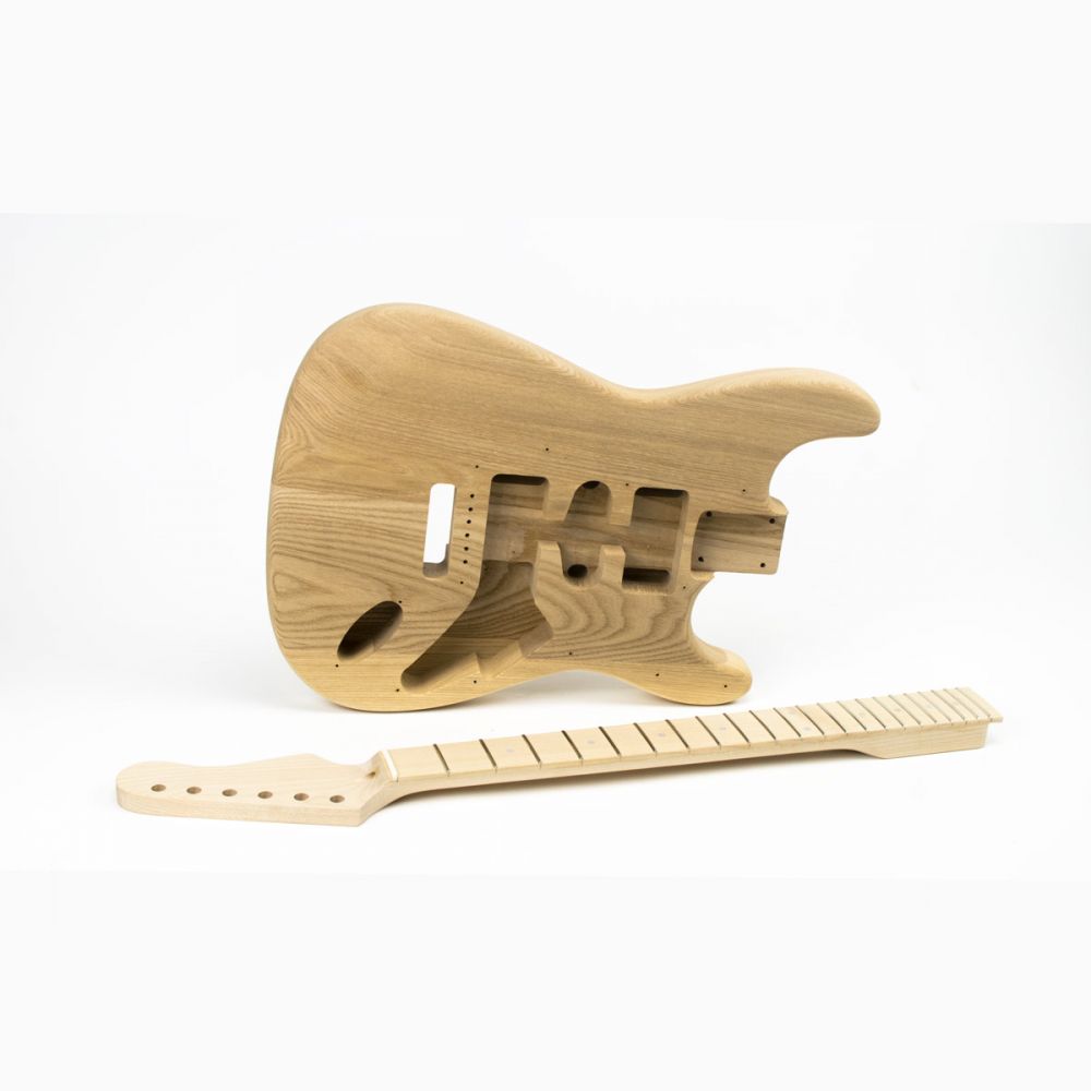 Unfinished ash body and maple neck shown from side angle displaying bolt-on construction and body contours.