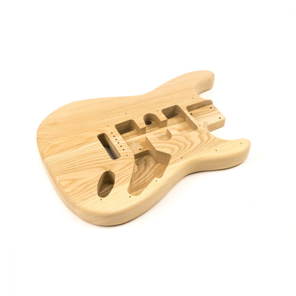 Unfinished ash body rear view showing routed cavities for electronics and tremolo system installation.