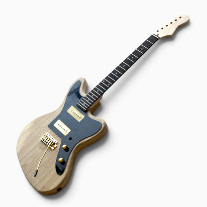 Unfinished offset guitar assembled from the kit: ash body, black pickguard, two cream soapbar pickups and gold tremolo bridge