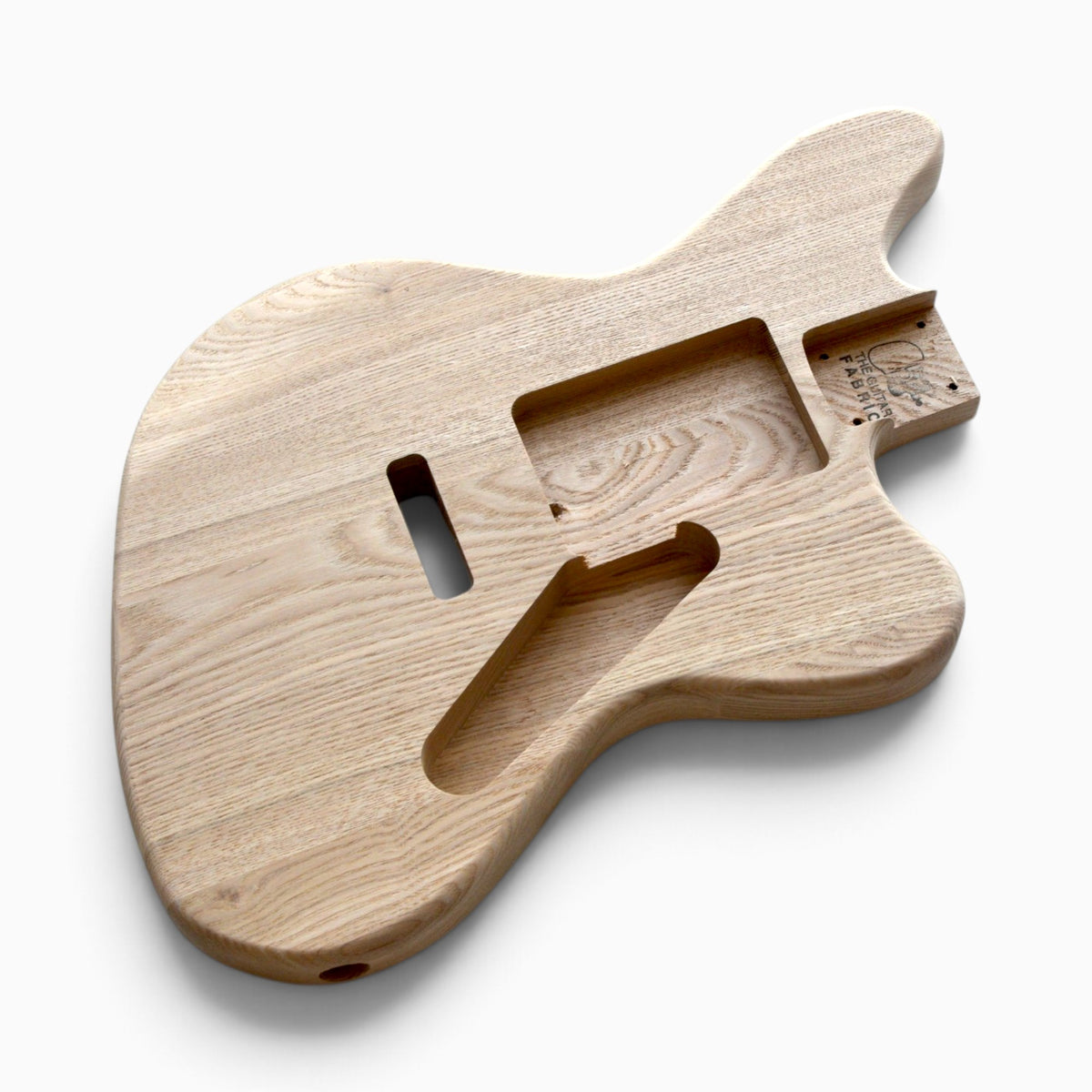 Front of the raw ash body with neck pocket, soapbar pickup routes and control cavity, ready for sanding and finishing