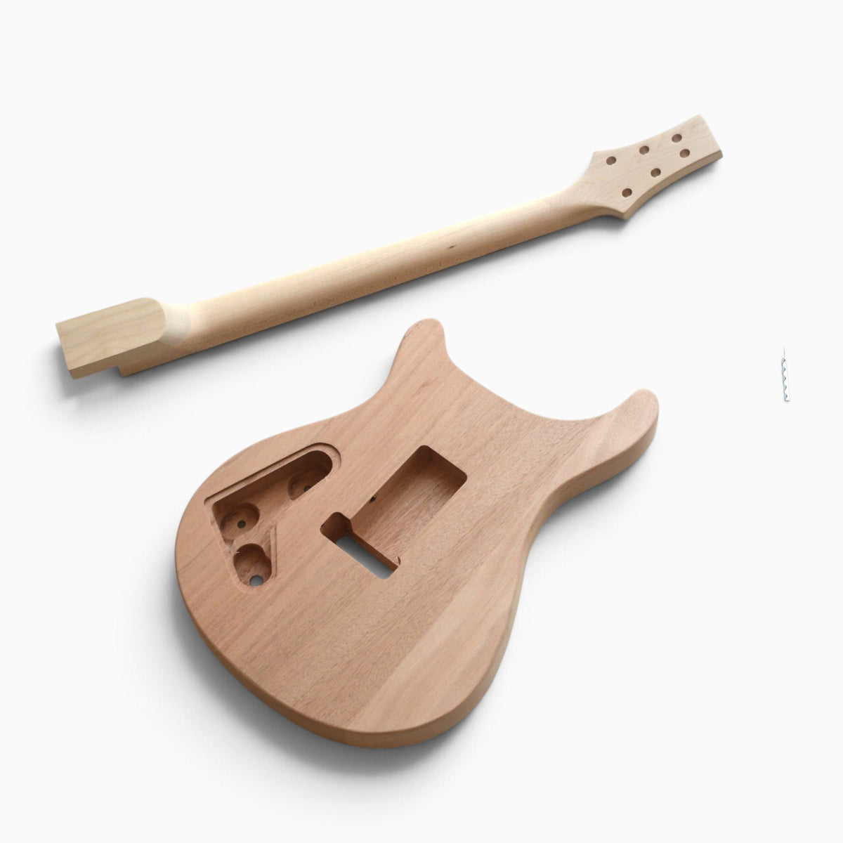 Back of the solid mahogany body with control and tremolo cavities beside the back of the maple neck