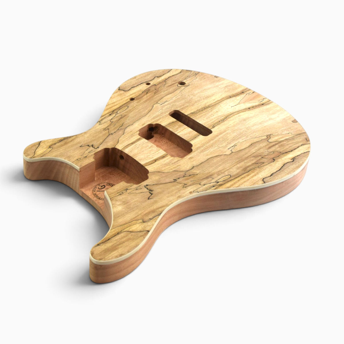 Side view of the body showing the spalted maple veneer over the solid mahogany back and the routed cavities