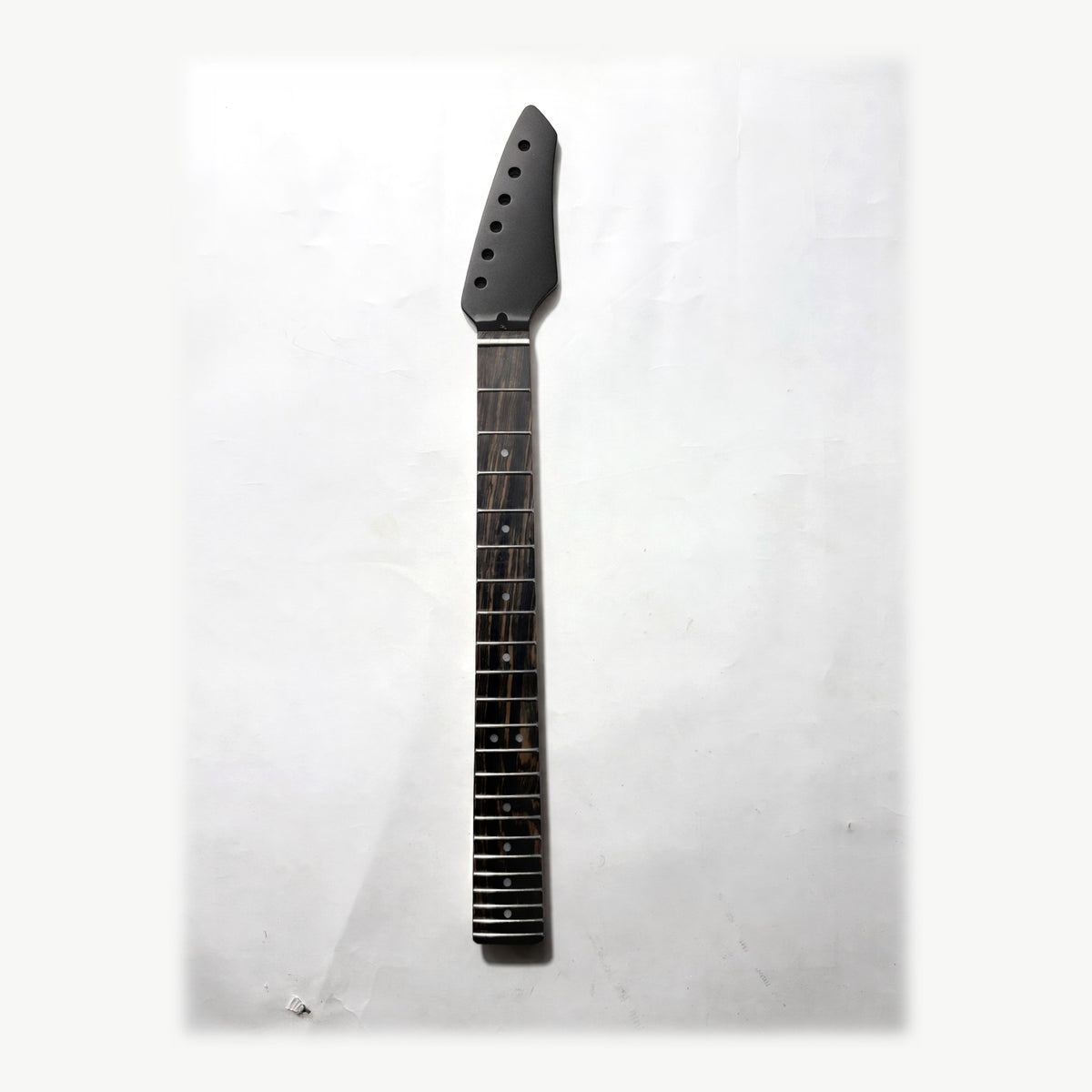 Sword headstock guitar neck in black satin paint, front with the ebony fretboard