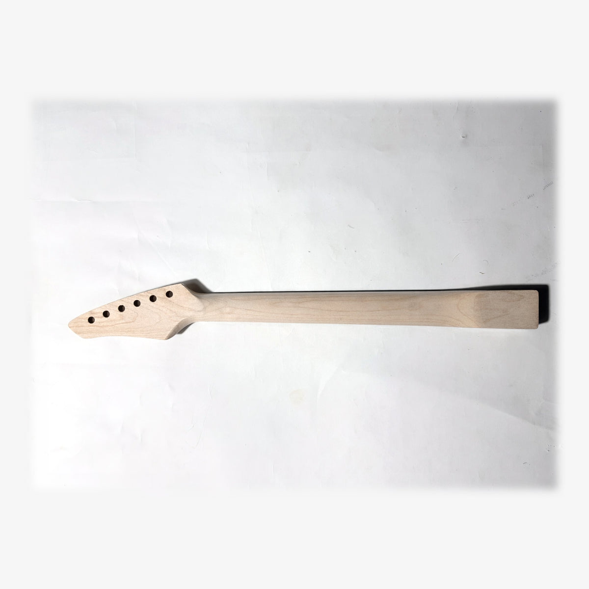 Back of the sword headstock guitar neck in unfinished bare maple
