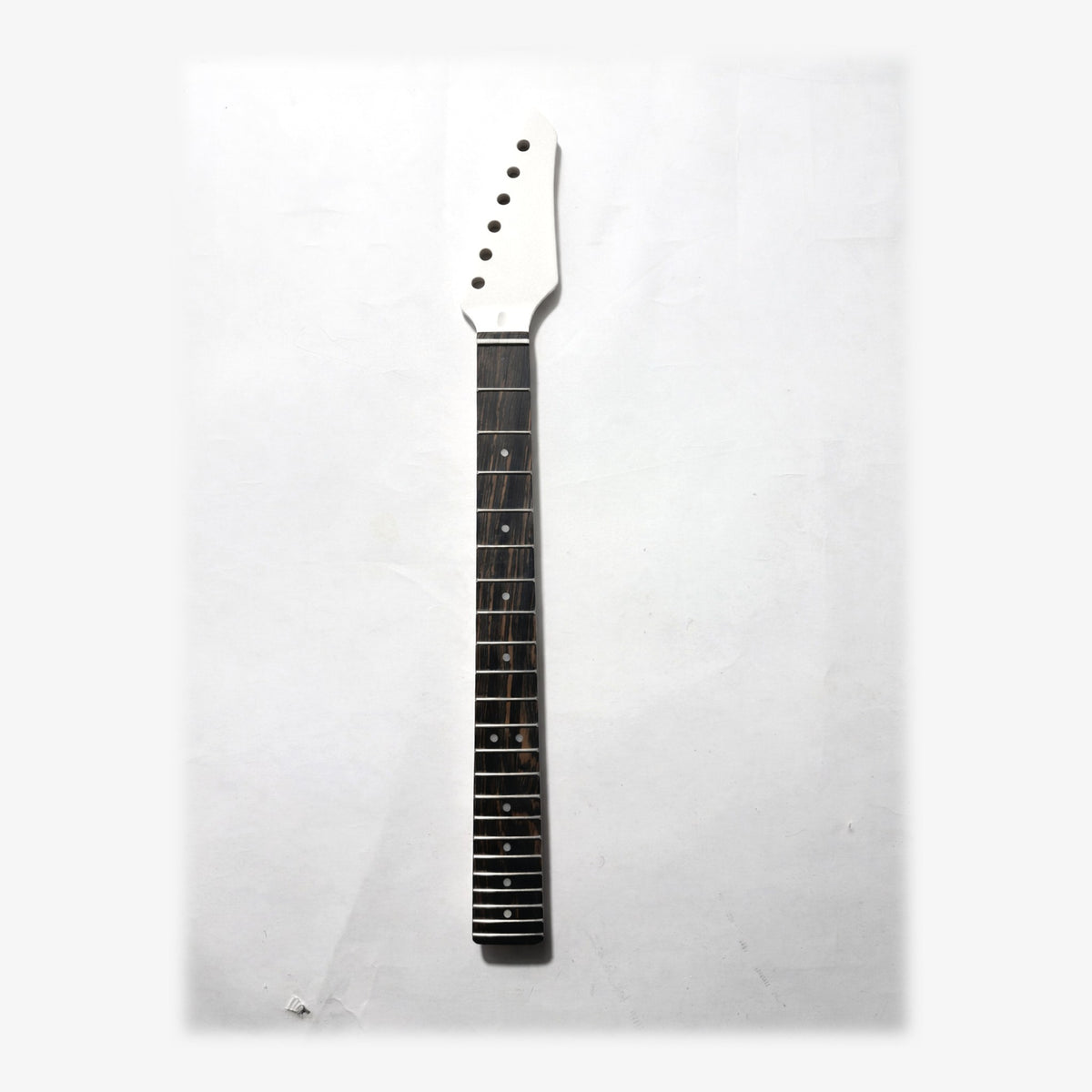 Sword headstock guitar neck in white matt paint, front with the ebony fretboard