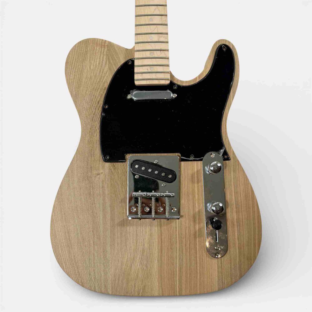 Fully assembled TL Classic guitar front view with black pickguard and chrome bridge hardware