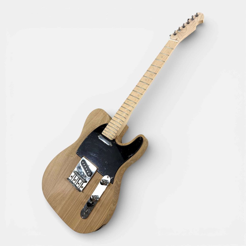 Completed TL Classic guitar angled side view showing ash body, maple neck, and all installed electronics