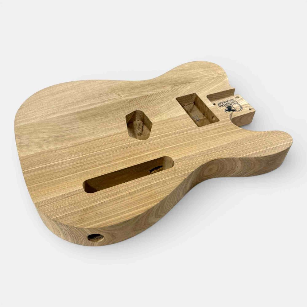 Ash body side angle view revealing contoured shape and internal routing for electronics installation