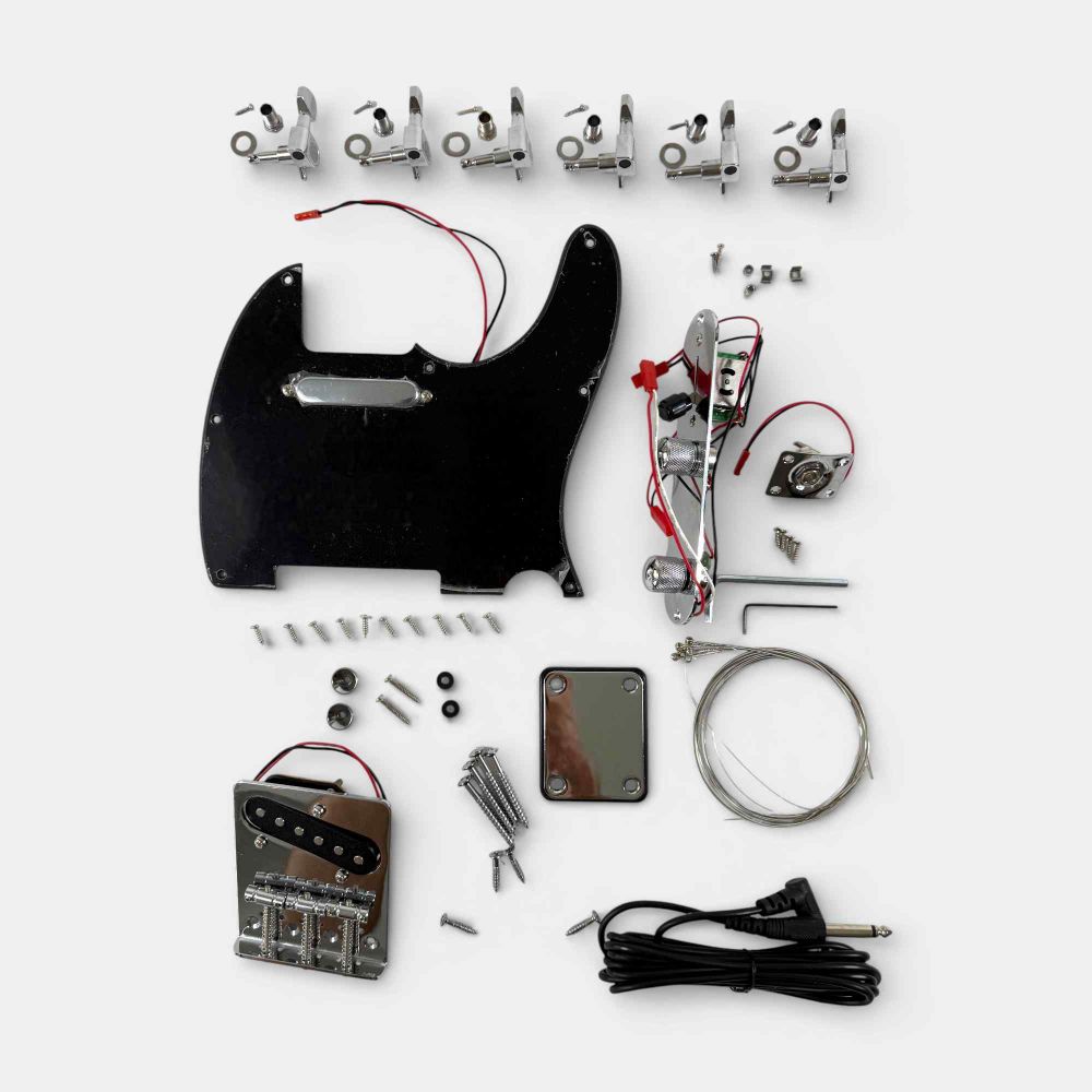 Close-up of solderless wiring electronics, black pickguard, tuning machines, and hardware components for kit assembly
